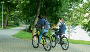 due ragazzi in bici in un parco di città