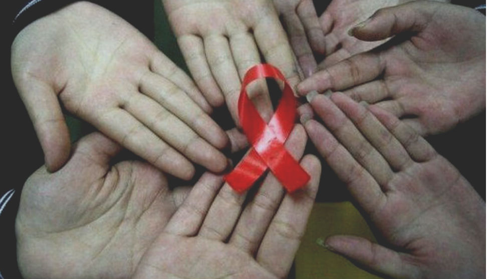 Virus HIV e aids, mani con fiocco rosso