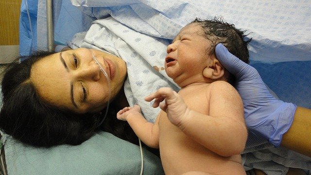 Una donna e un neonato al momento del parto